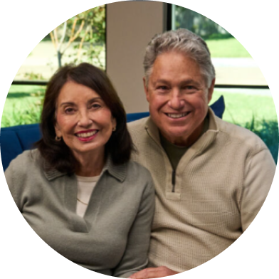 Image of Rudi seating beside his wife and caregiver Diana